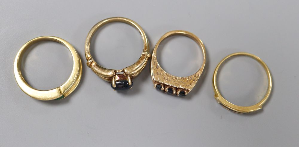 An 18ct gold, emerald and diamond asymmetric ring, an 18ct channel-set sapphire and diamond half-eternity ring and two 9ct rings